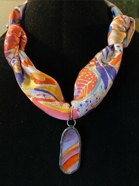 Repurposed handmade glass pendant on a new scarf.